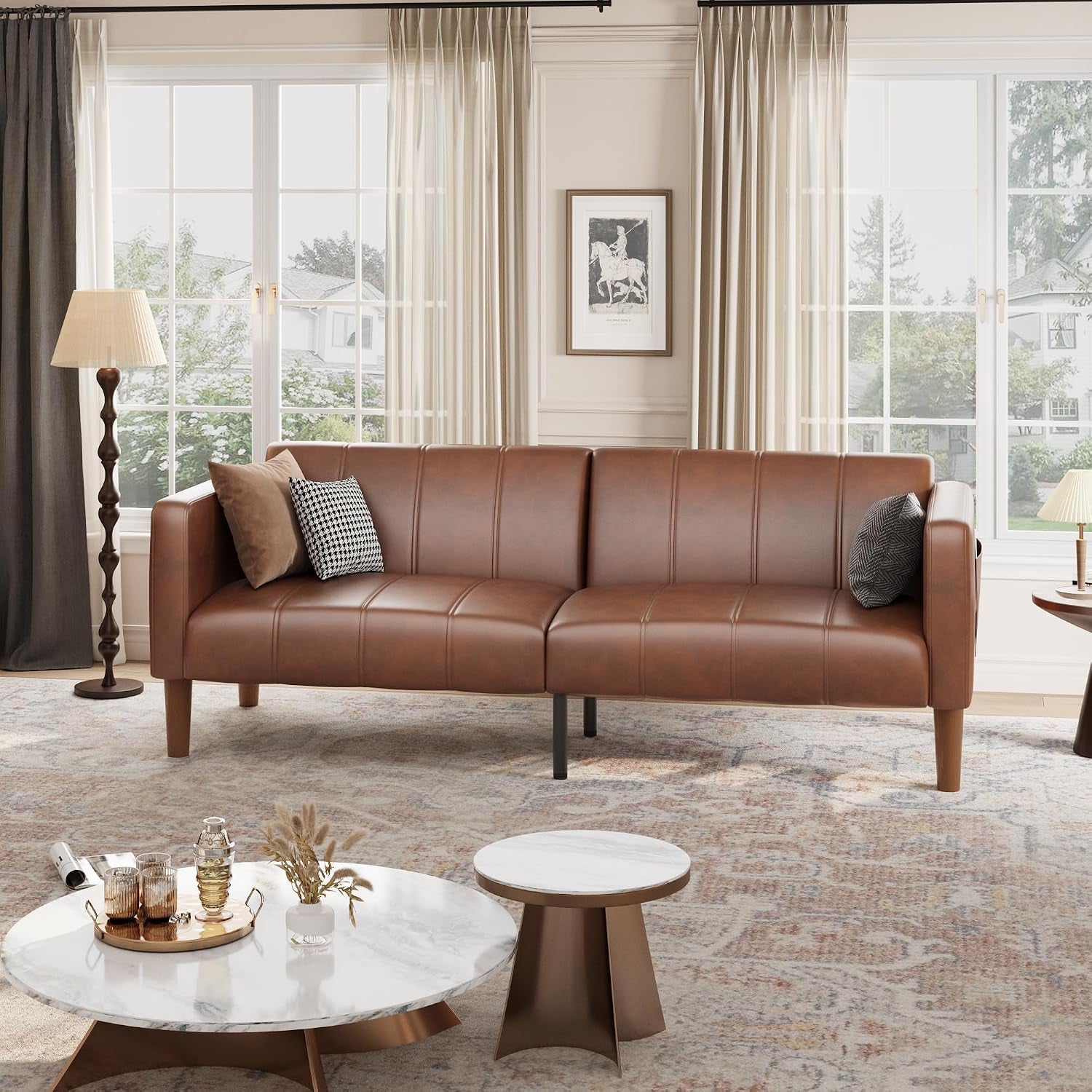Brown faux leather futon sofa front view staged in a bright room with windows