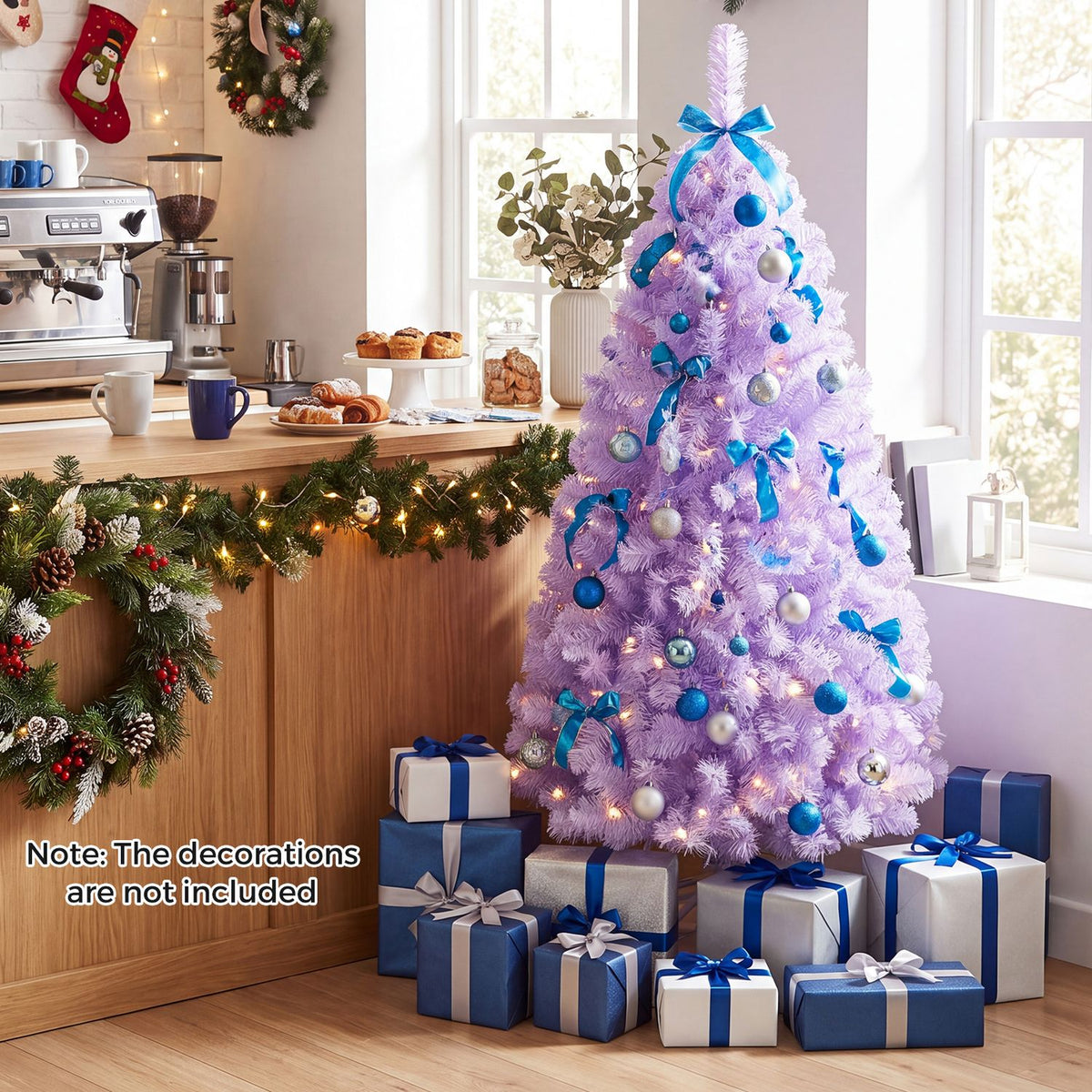 Lavender lit Christmas tree with blue decorations and wrapped presents in a bright kitchen.