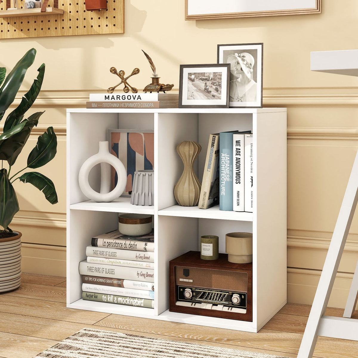 White cube bookshelf filled with books and decor, shown against a warm yellow wall.