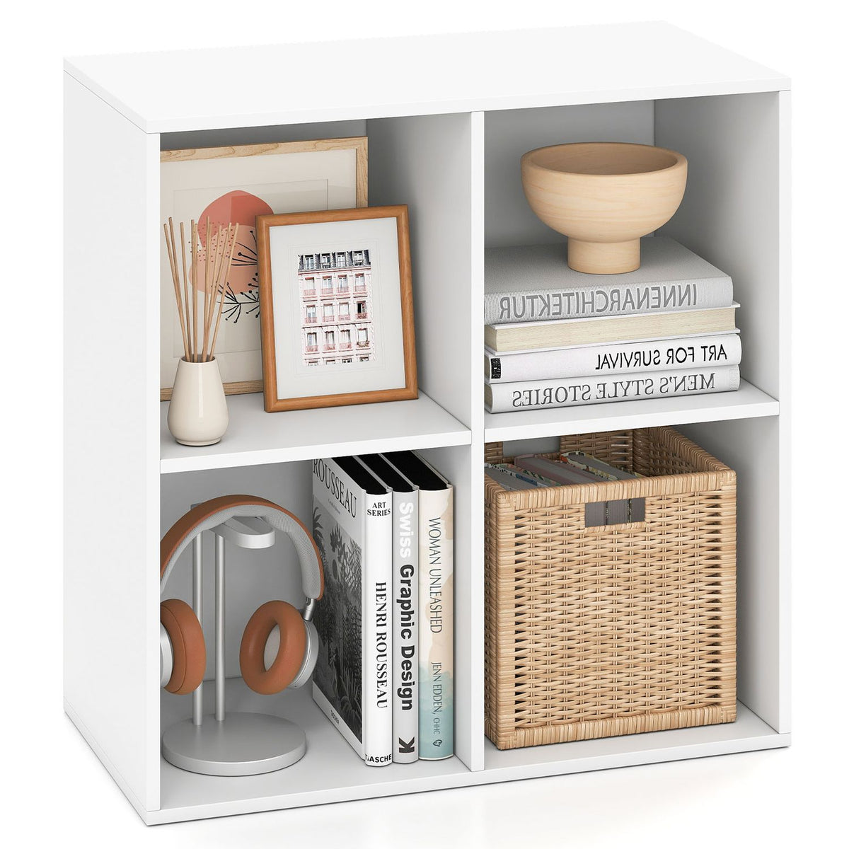 White four-cube shelf displayed on a white background with books, a basket and decorative objects.