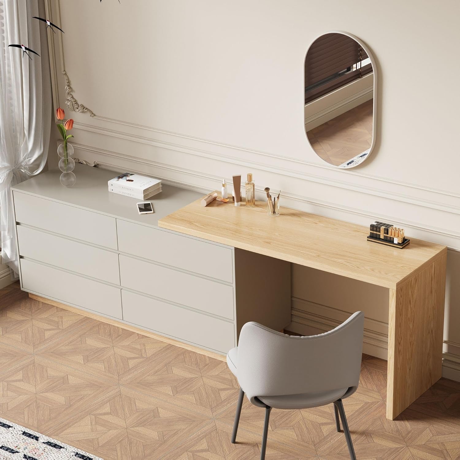 Closed six-drawer beige dresser joined to a light wood desk with a grey chair in front and oval wall mirror