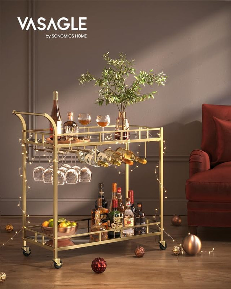 Bar cart styled in a living room with string lights, bottles on shelves and a red armchair at right.