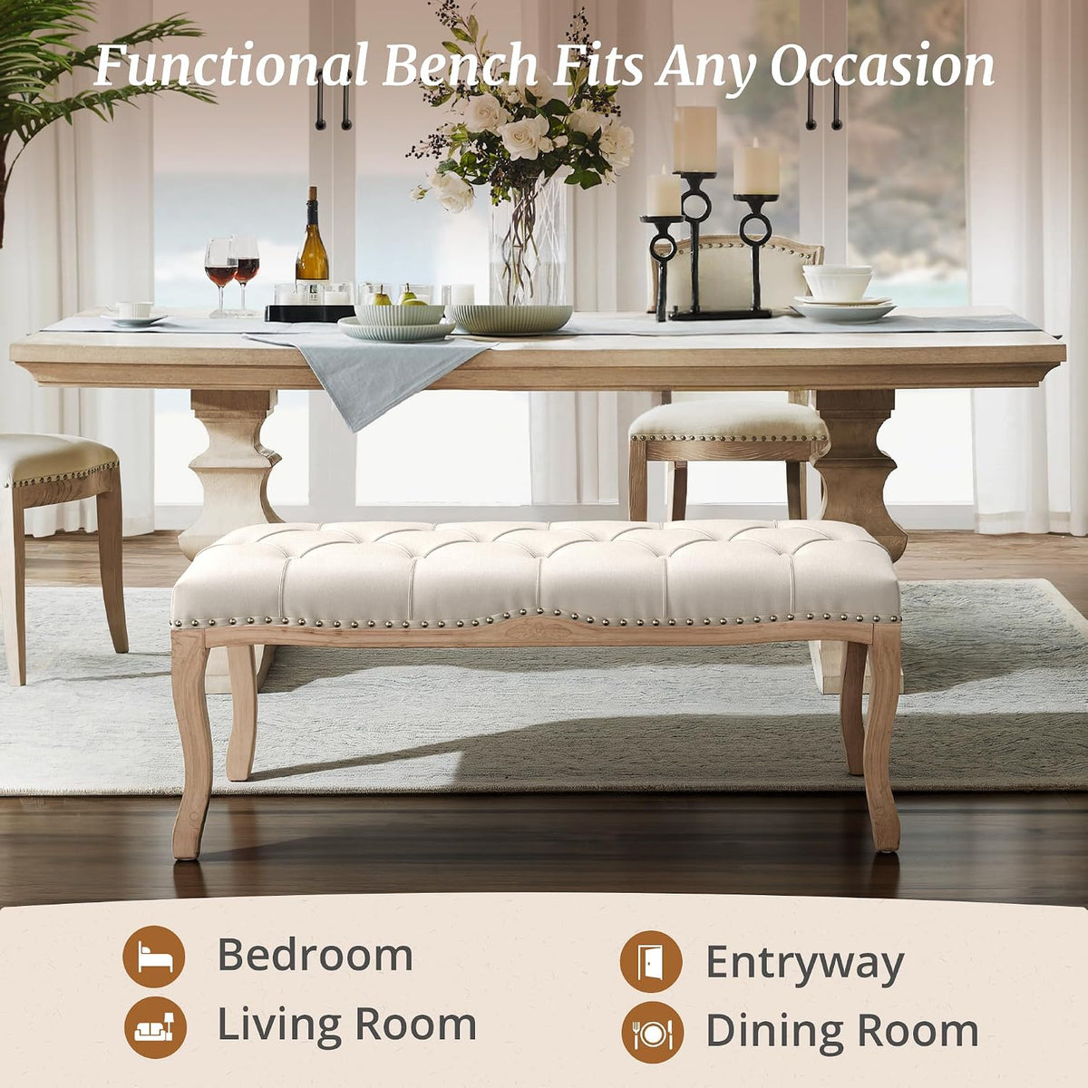 Beige linen tufted bench staged in a dining room setting with carved wooden legs visible in front of a table
