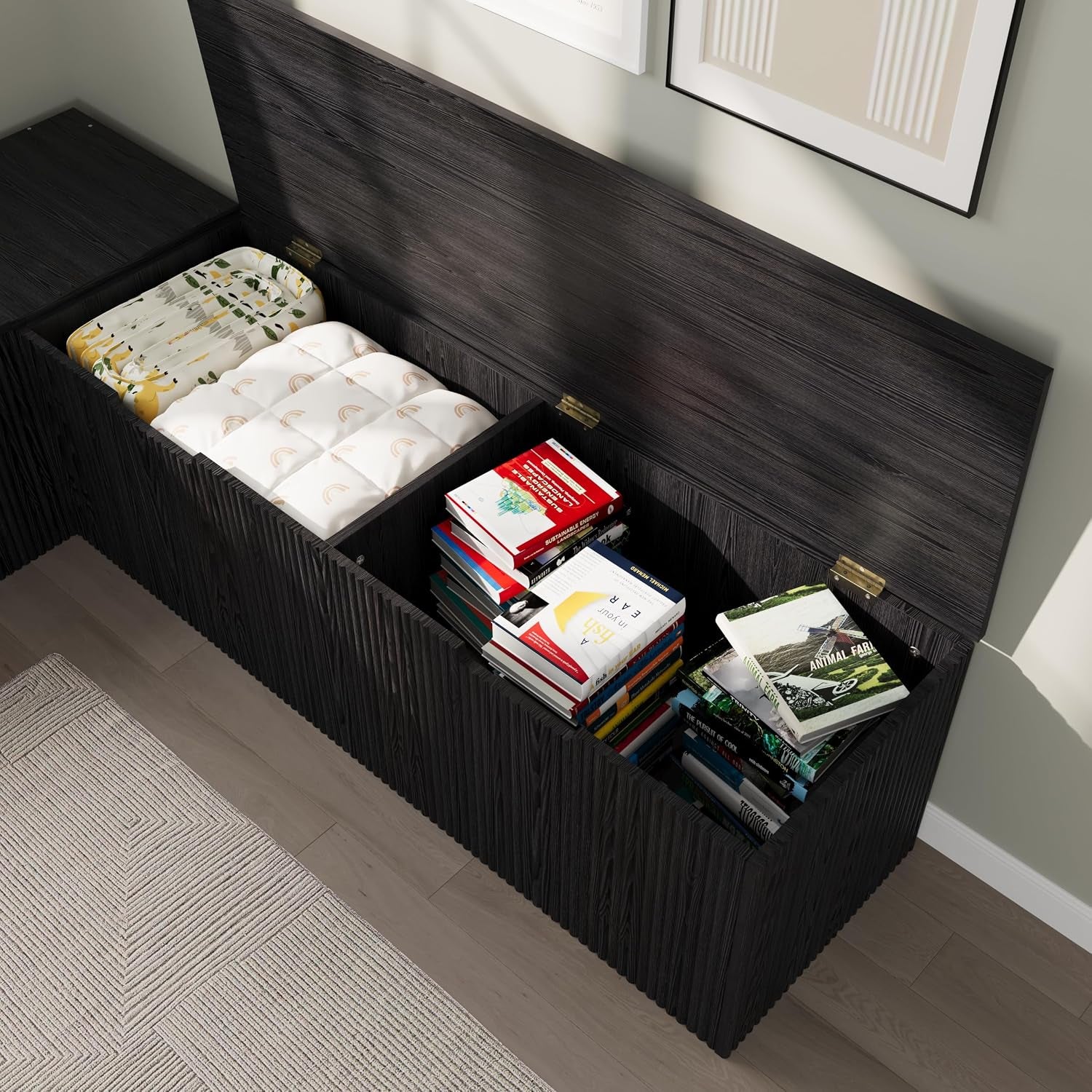 Top-down view of the bench with three lids open, showing stacked books and folded linens inside