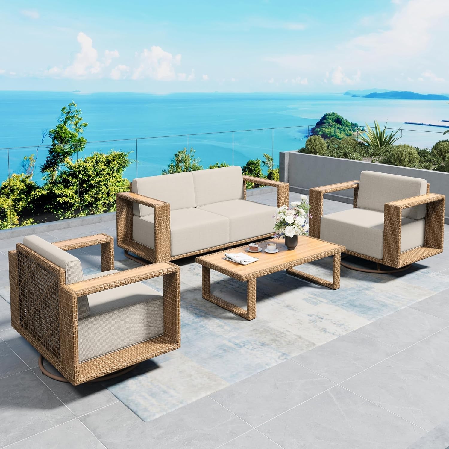 Two cube-style armchairs and a low rectangular coffee table on a pale patterned outdoor rug.