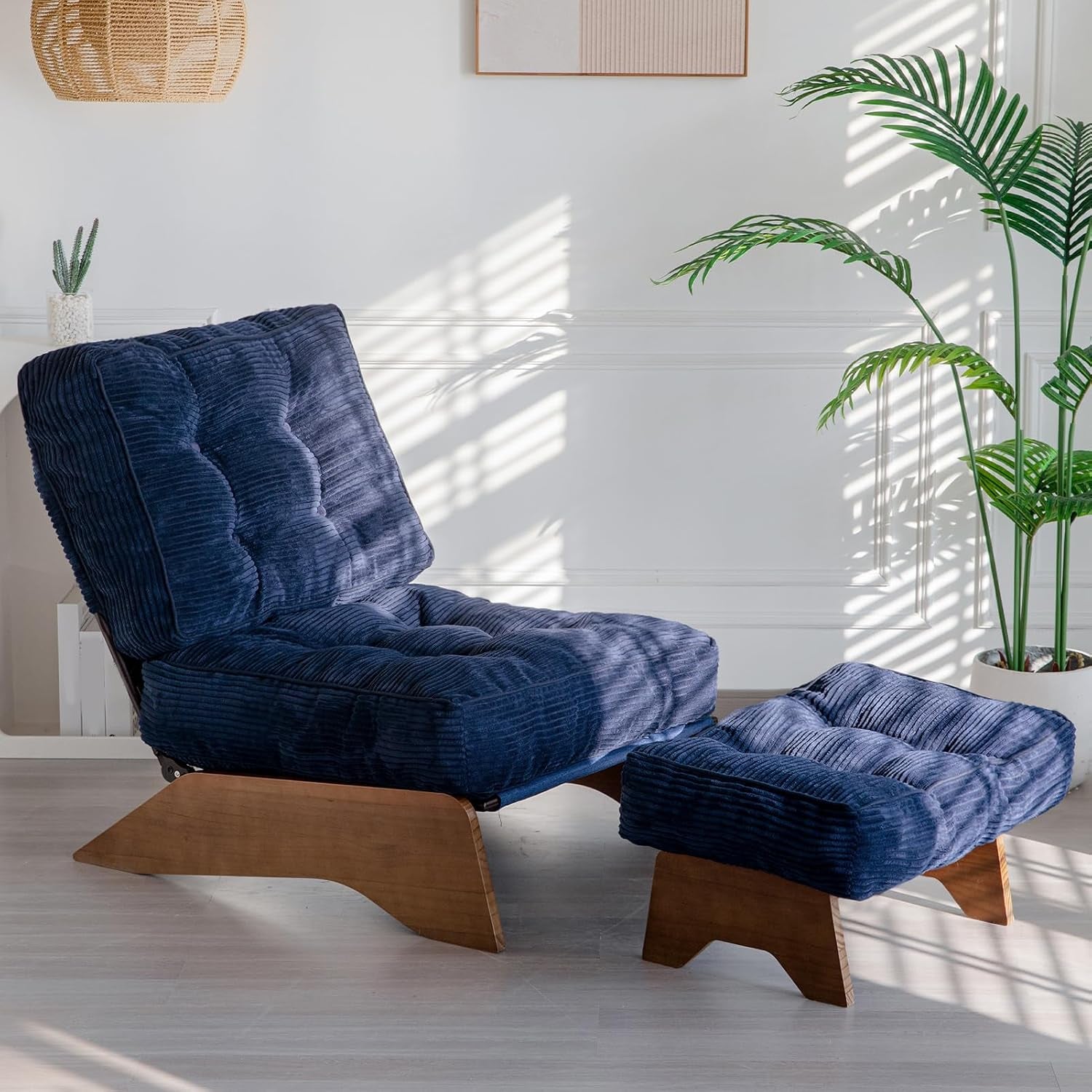 Navy blue corded fabric adjustable-back chair paired with a tufted ottoman on wood bases.