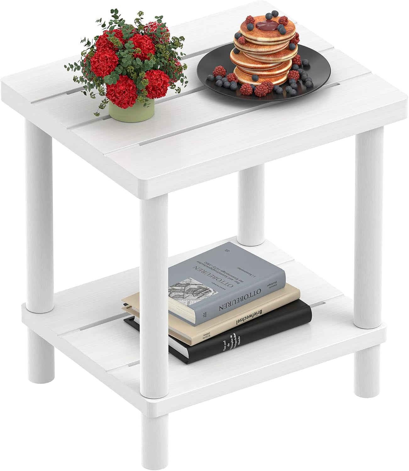Angled view of a small white two-tier side table with a flower pot on top and stacked books on the lower shelf.