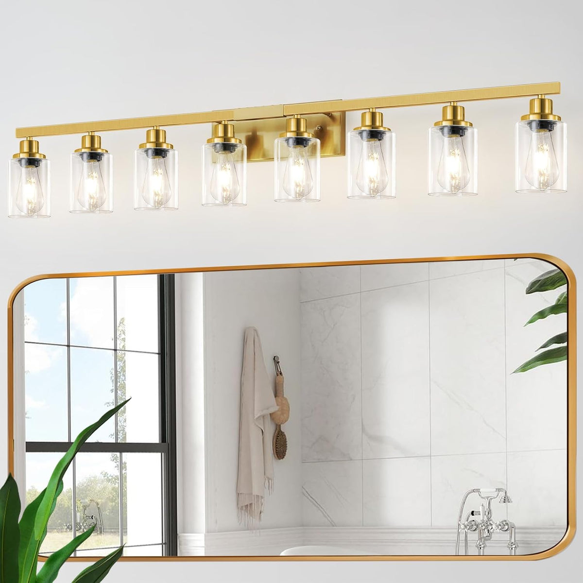 Eight-light gold-finish vanity bar with clear glass shades reflected above a large rectangular mirror.