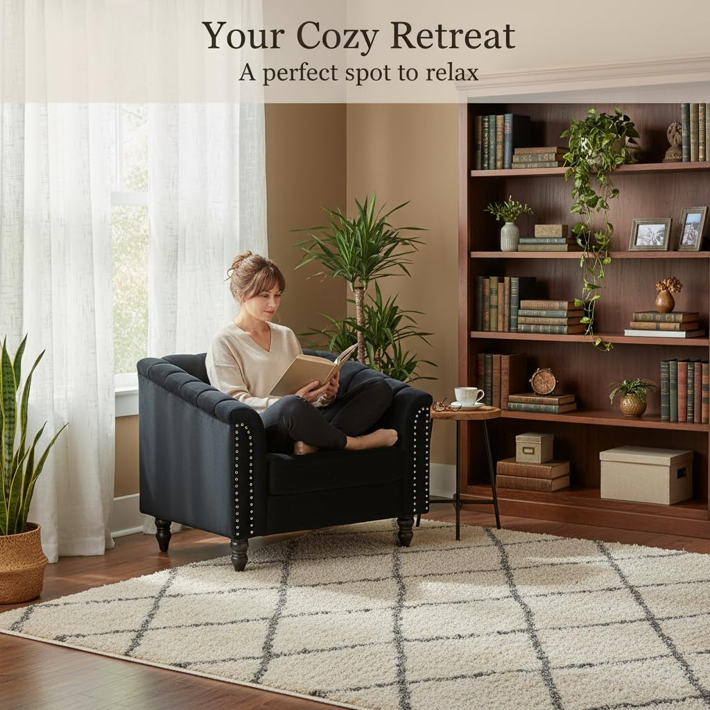 Black velvet armchair arranged in a cozy reading corner with bookshelf and area rug