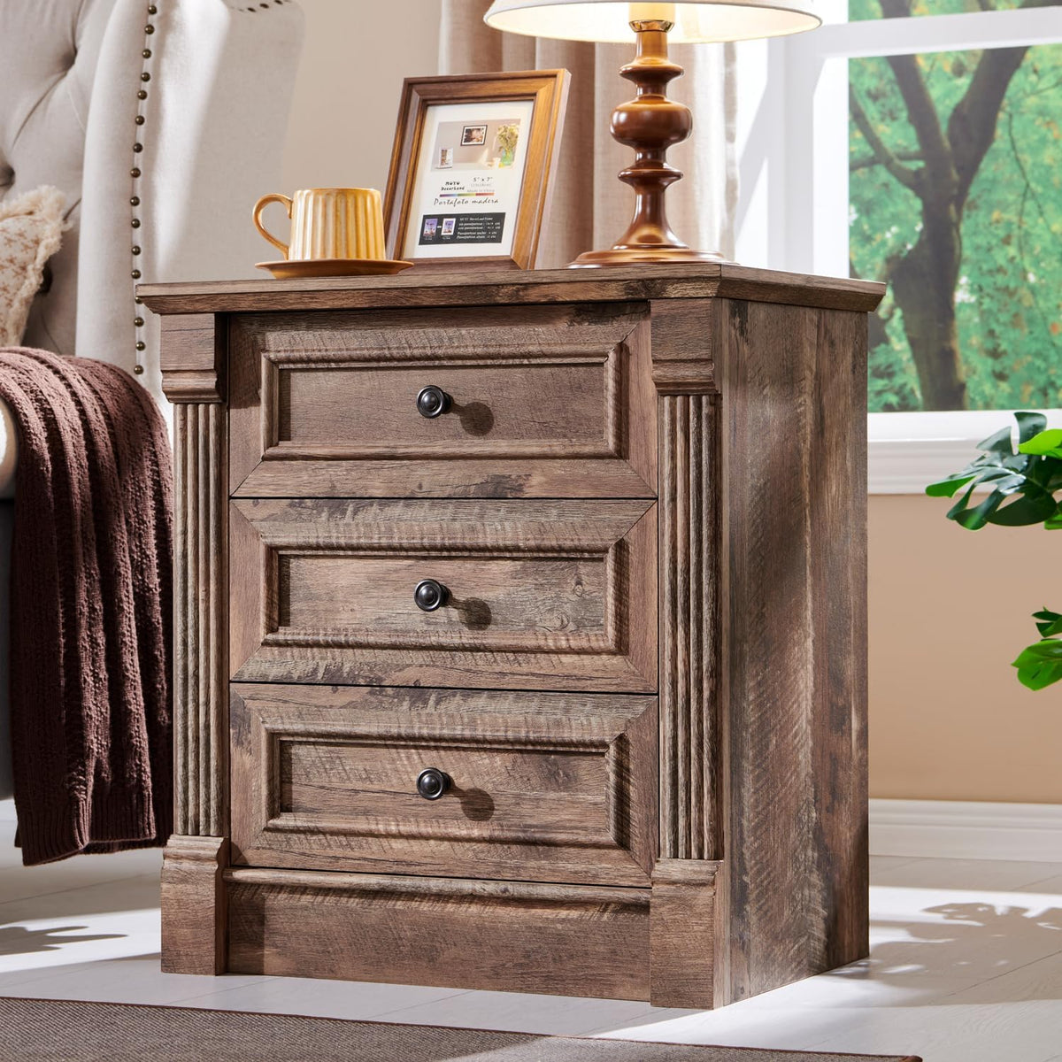 Three-drawer nightstand in warm brown wood tone with round metal knobs and carved column accents.