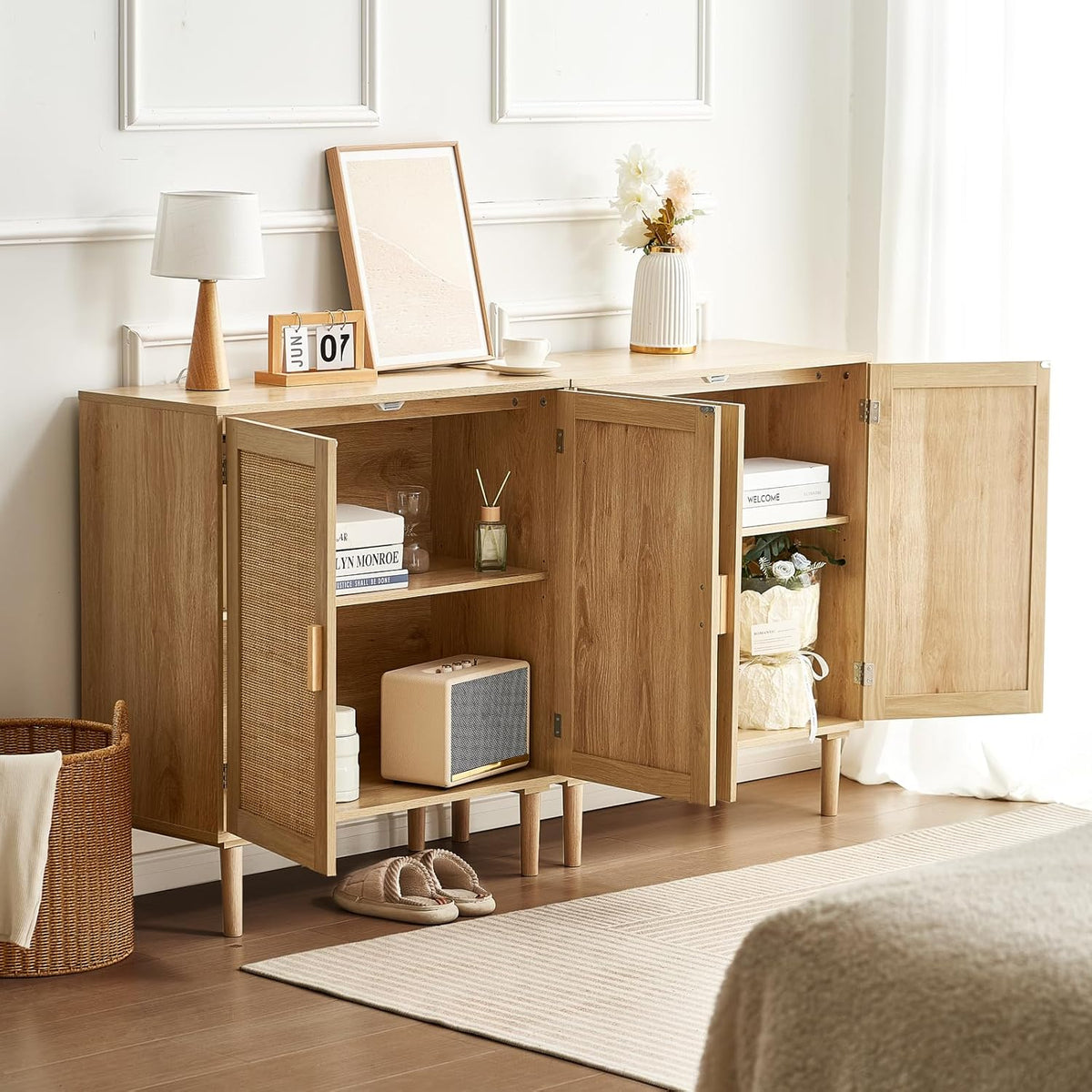 Rattan buffet cabinet with both doors open showing adjustable interior shelves and staged household items inside