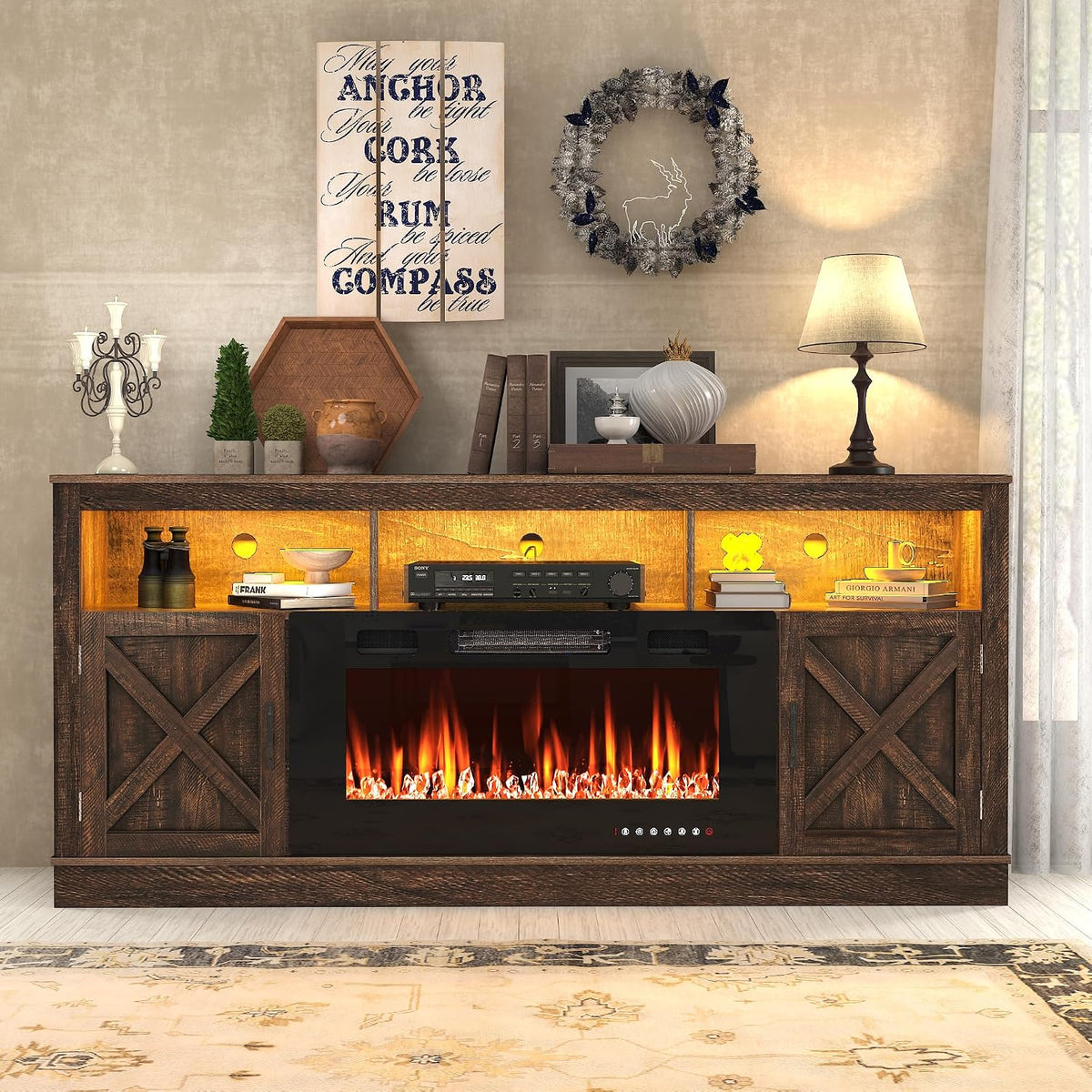 Straight-on crop of the dark wood console top with decorative wall art, wreath and tabletop accessories above the fireplace.
