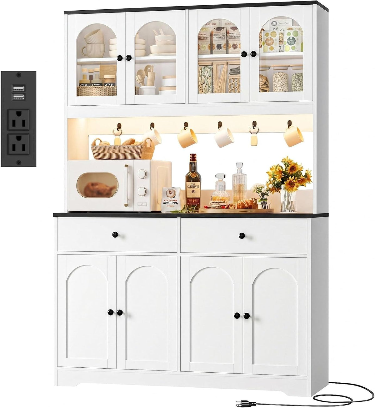 White pantry hutch with black countertop edge, microwave and floral arrangement on the work surface