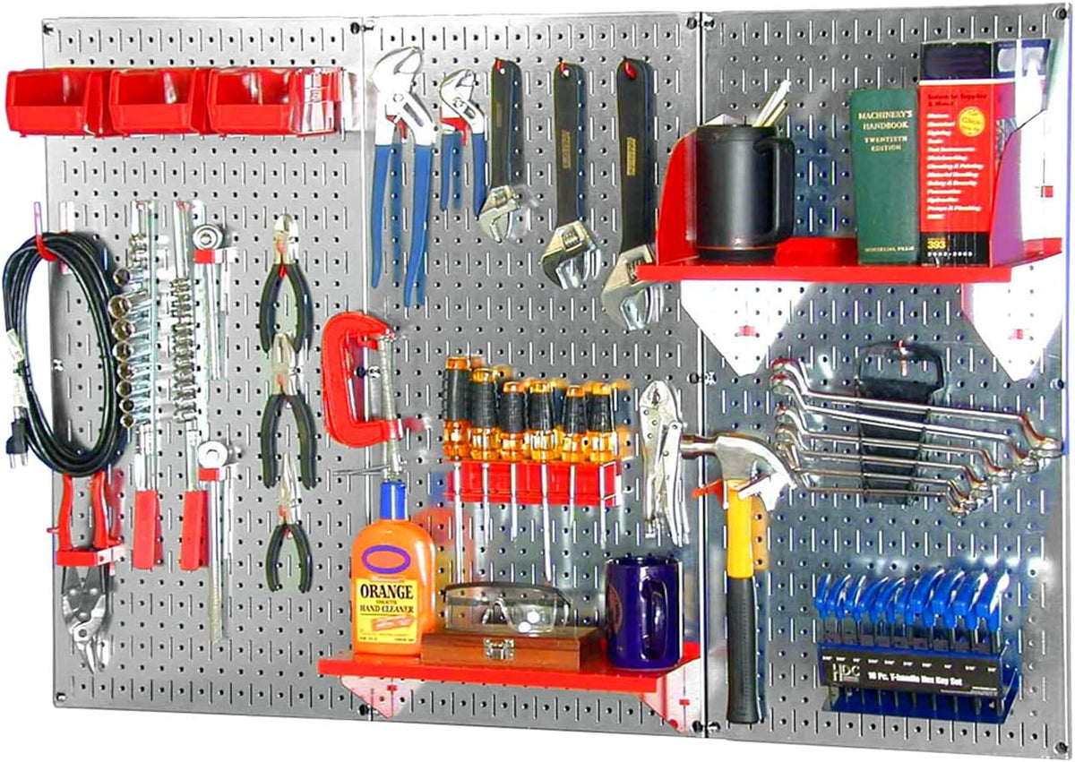 Silver pegboard with red shelves and bins holding pliers, clamps, screwdrivers and an orange hand-cleaner bottle