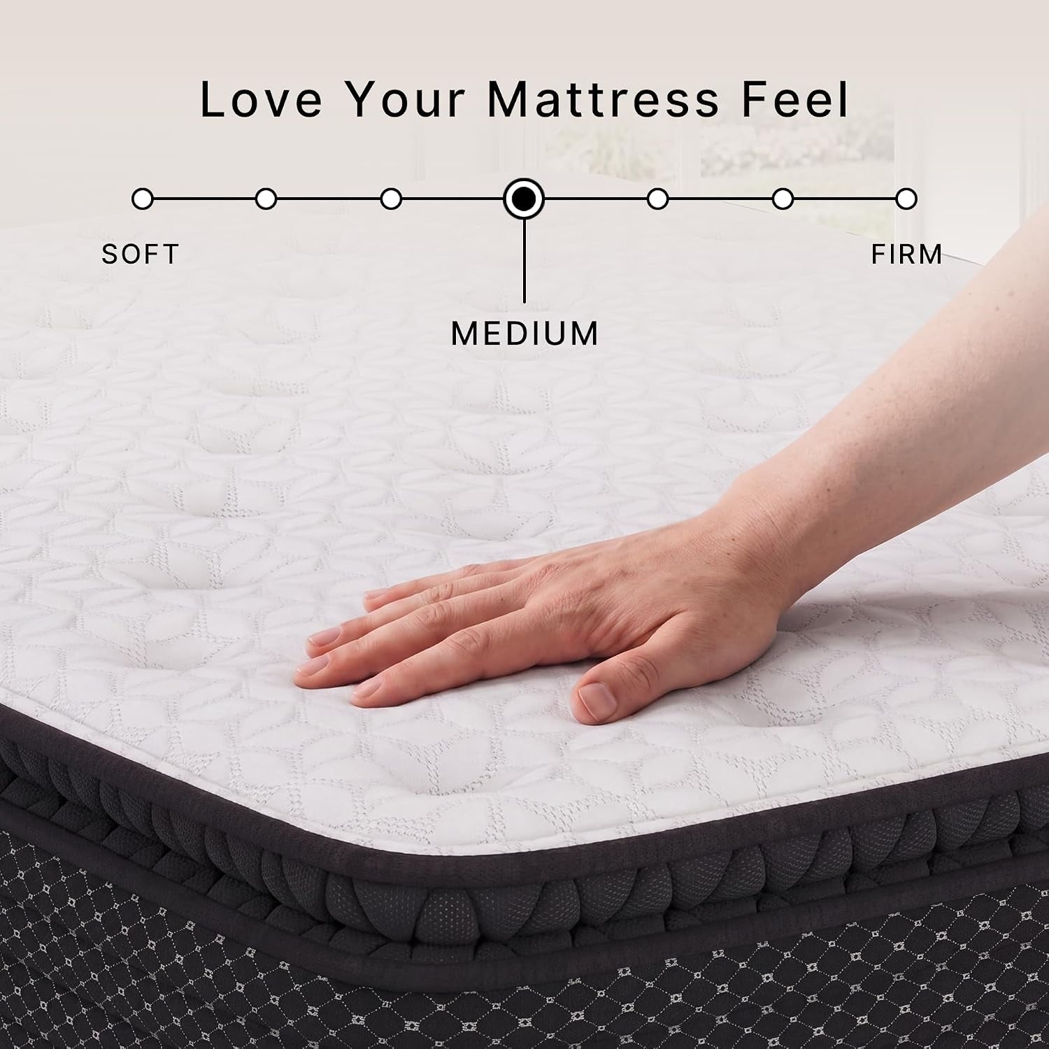 Close-up of the white quilted pillow-top surface with a hand pressing down to show cushioning and medium feel