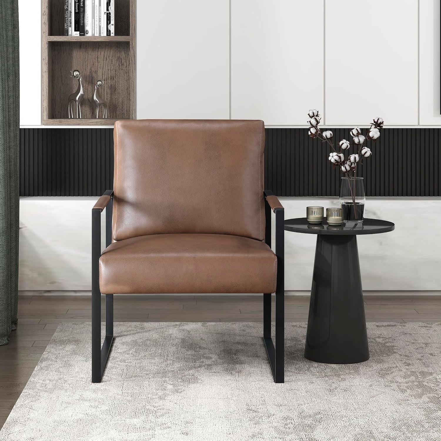 Straight-on front view of brown faux leather accent chair in a living room setting with side table
