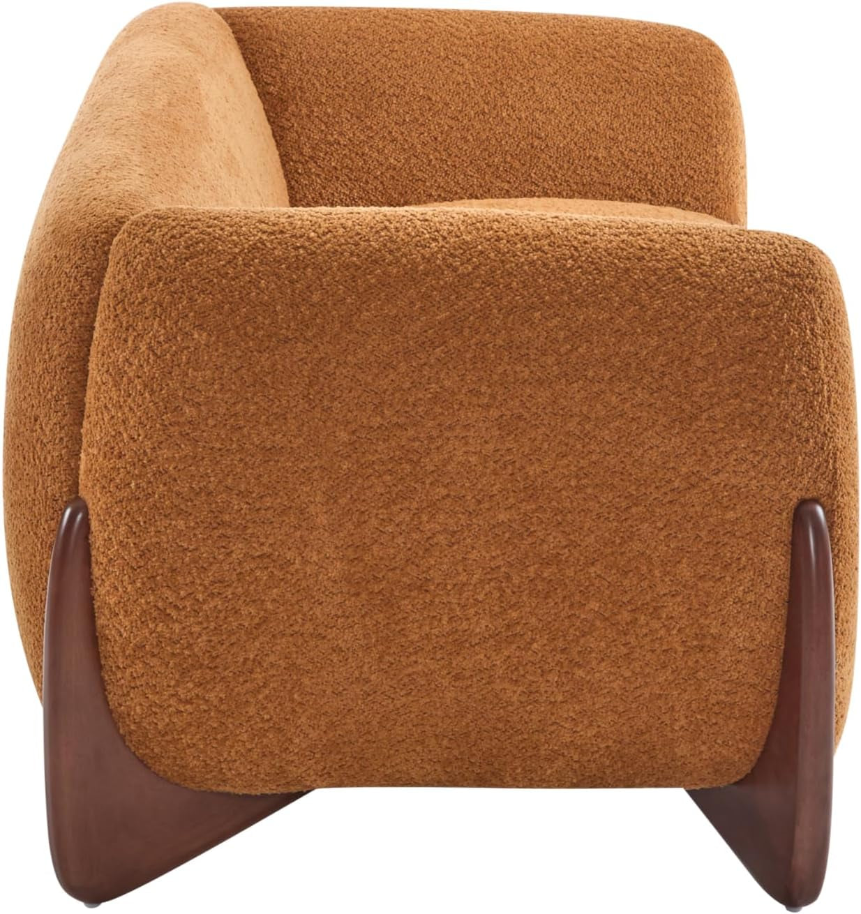 Close side view of the sofa's rounded arm and tapered dark wooden leg in caramel brown boucle.