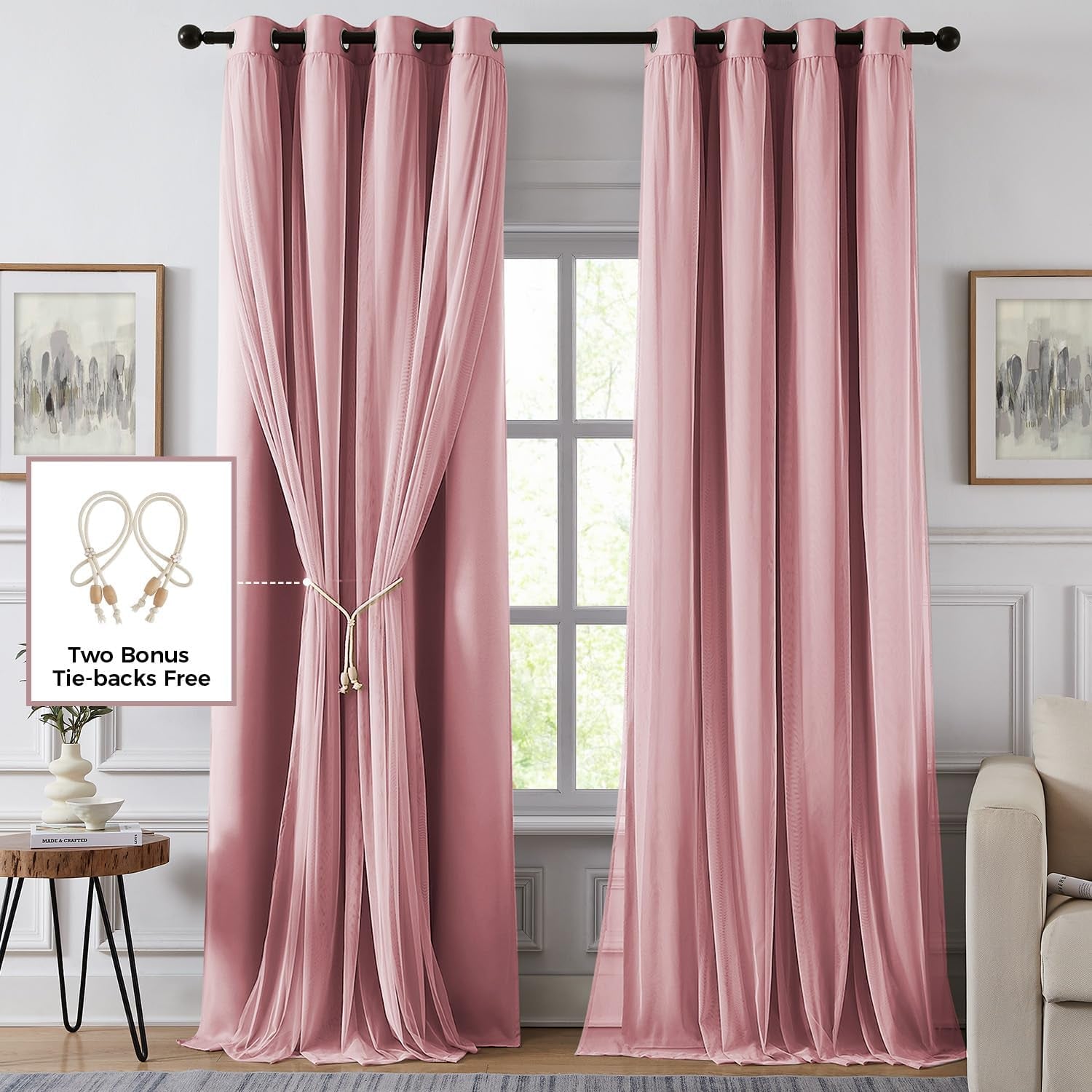 Full-length pink curtain panels with light sheer overlay gathered and secured with a tie-back accent.