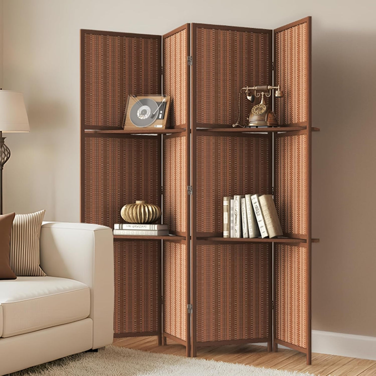 Four-panel bamboo folding screen angled in a corner with integrated shelves holding books and decorative objects