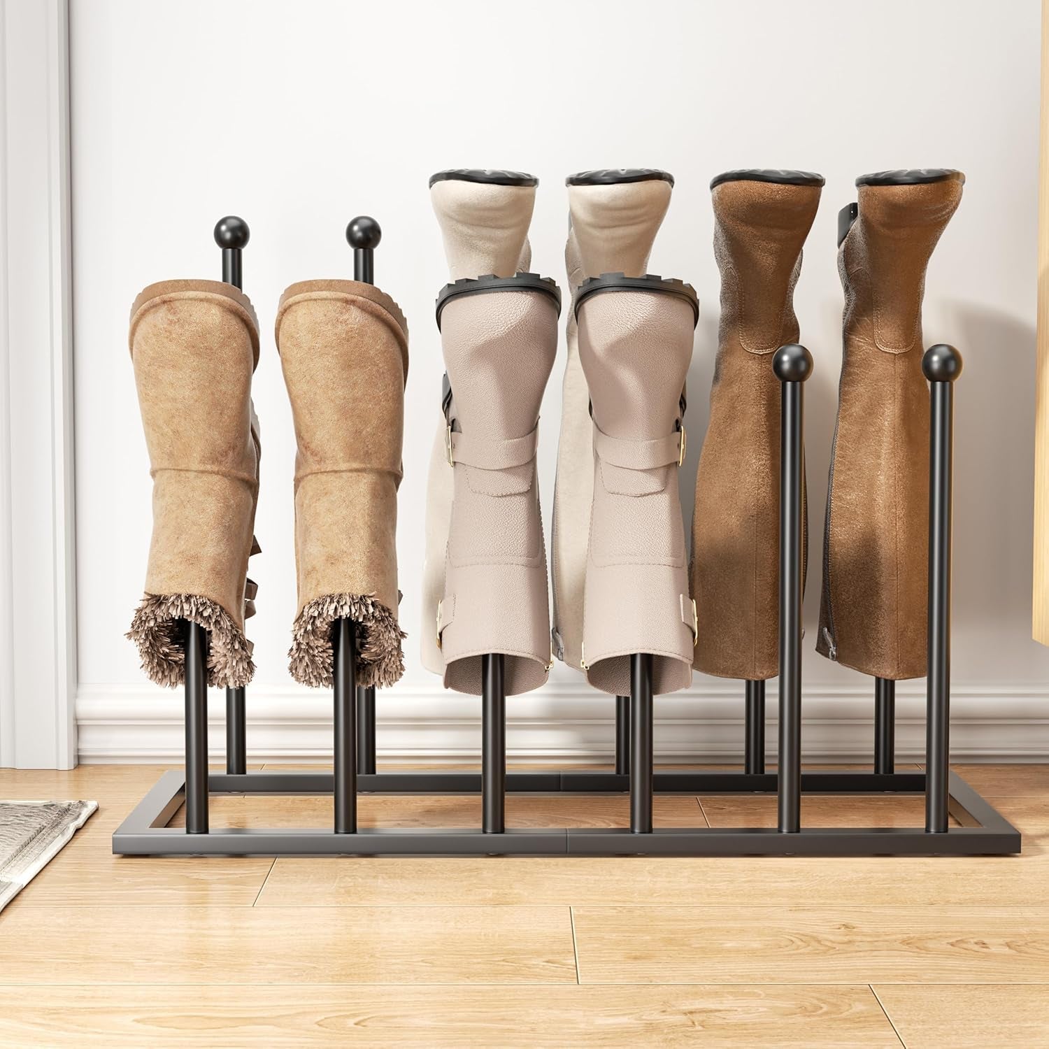 Center-front view of a black boot rack on a wood floor with boots inserted, highlighting the rectangular base and