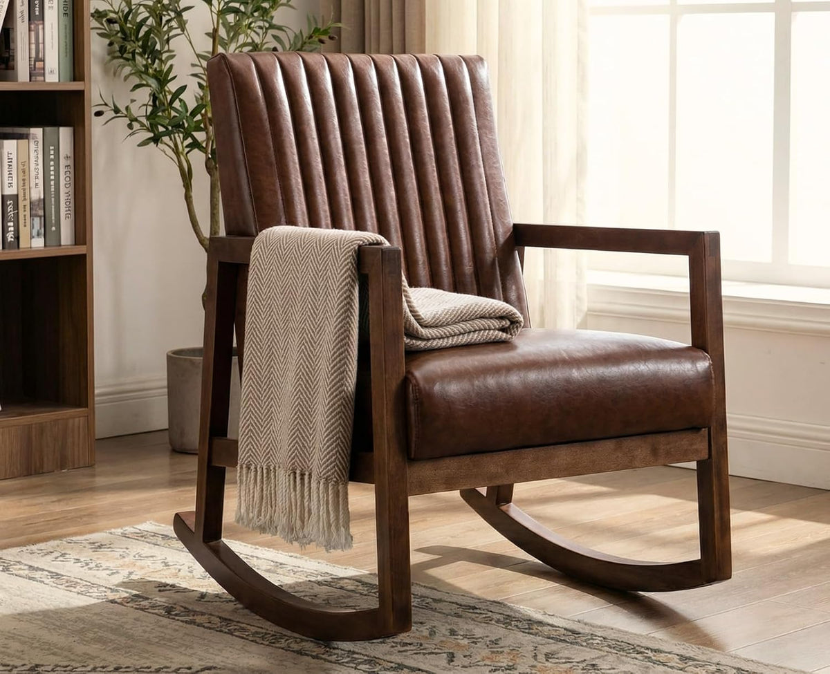 Brown faux leather mid-century rocking chair angled front view with blanket in a bright living room