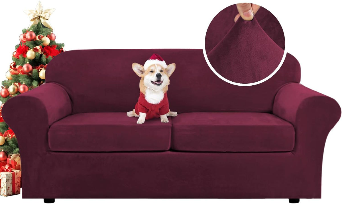 Burgundy three-seat slipcovered sofa with a small corgi in a Santa outfit on the cushions and a decorated Christmas tree at