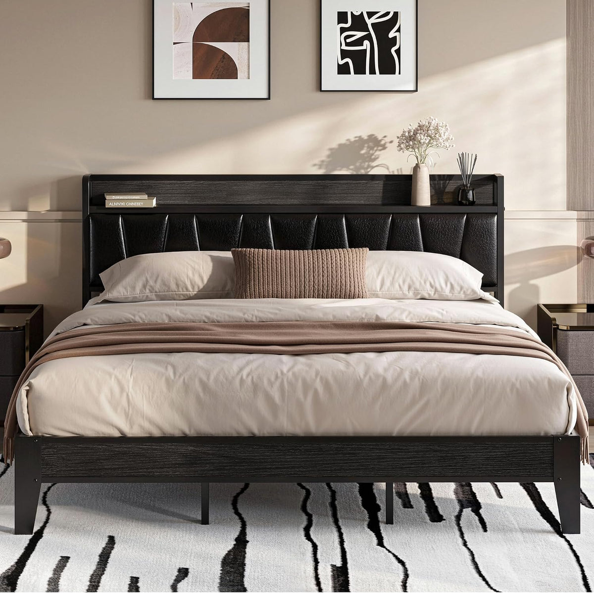 Front view of bed in dark finish with black upholstered headboard, neutral bedding and a patterned rug below.