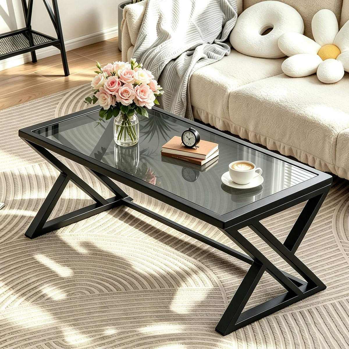 Staged living-room view of a rectangular table with black X-legs and a reflective smoked glass top next to a beige sofa