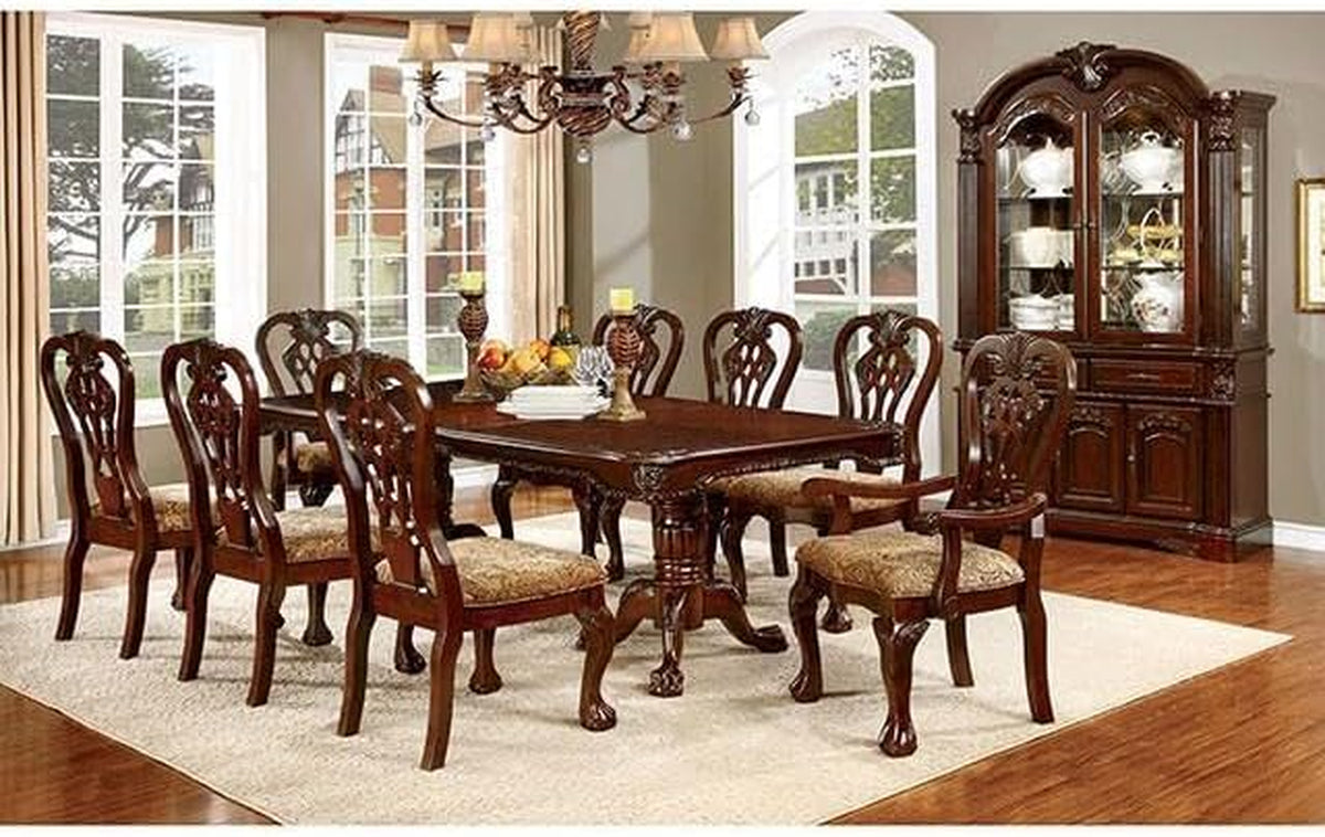 Dining room scene with brown cherry hutch and buffet at rear alongside matching carved dining table and chairs