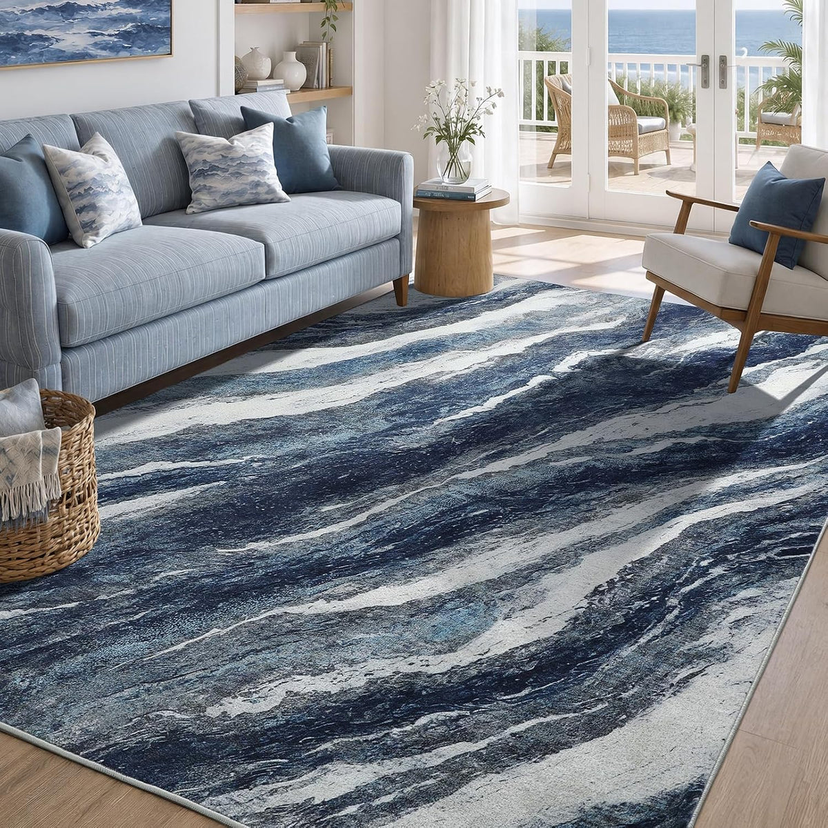 Low-angle view across the rug showing dark navy and indigo marbled waves in the foreground of a coastal living room.