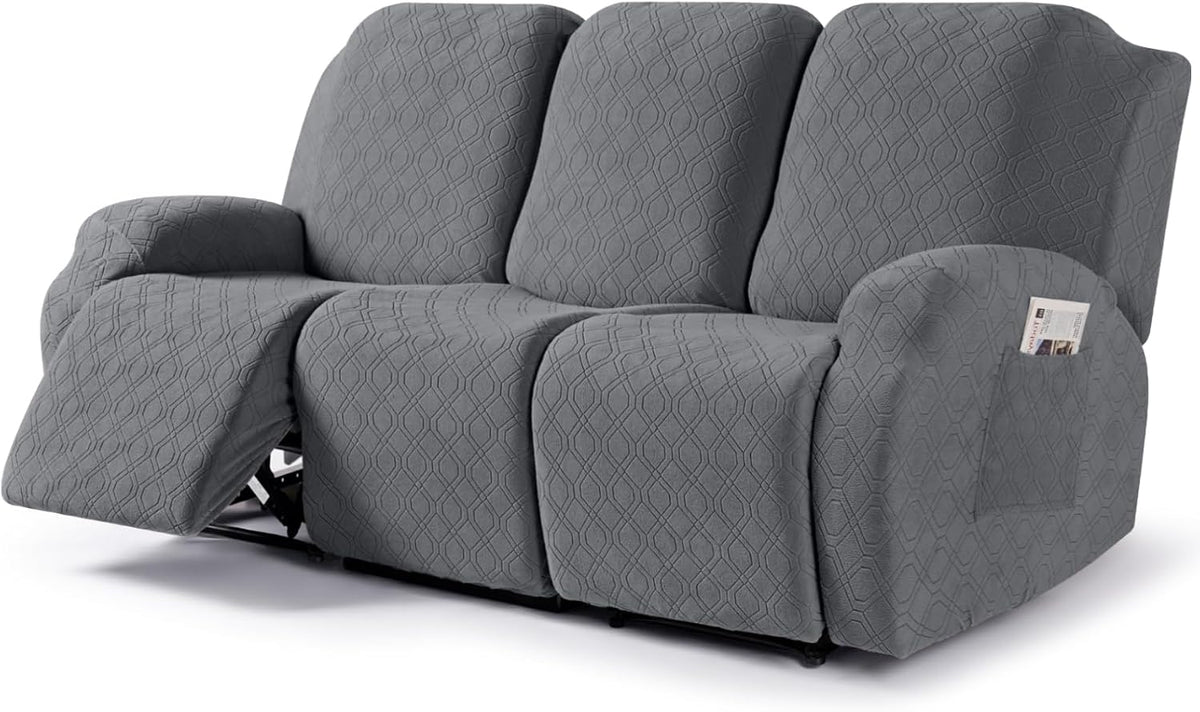 Dark gray three-piece recliner slipcover on a white background showing side pocket and extended left footrest