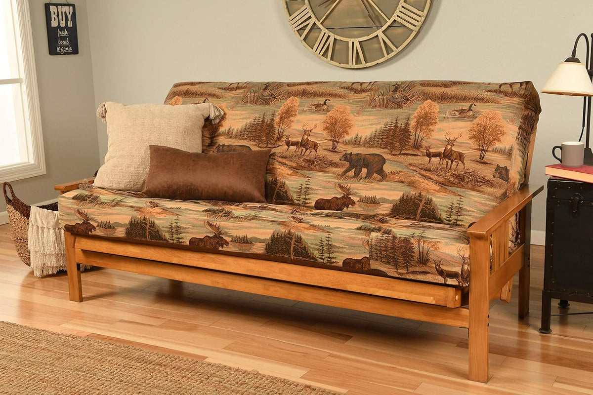 Futon in patterned outdoors-themed fabric on a warm honey wood frame with throw pillows