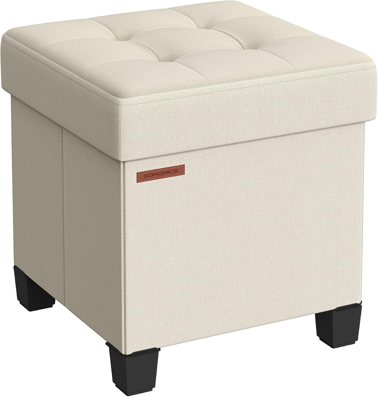 Three-quarter view of a cream linen-look storage ottoman with tufted top and black block legs