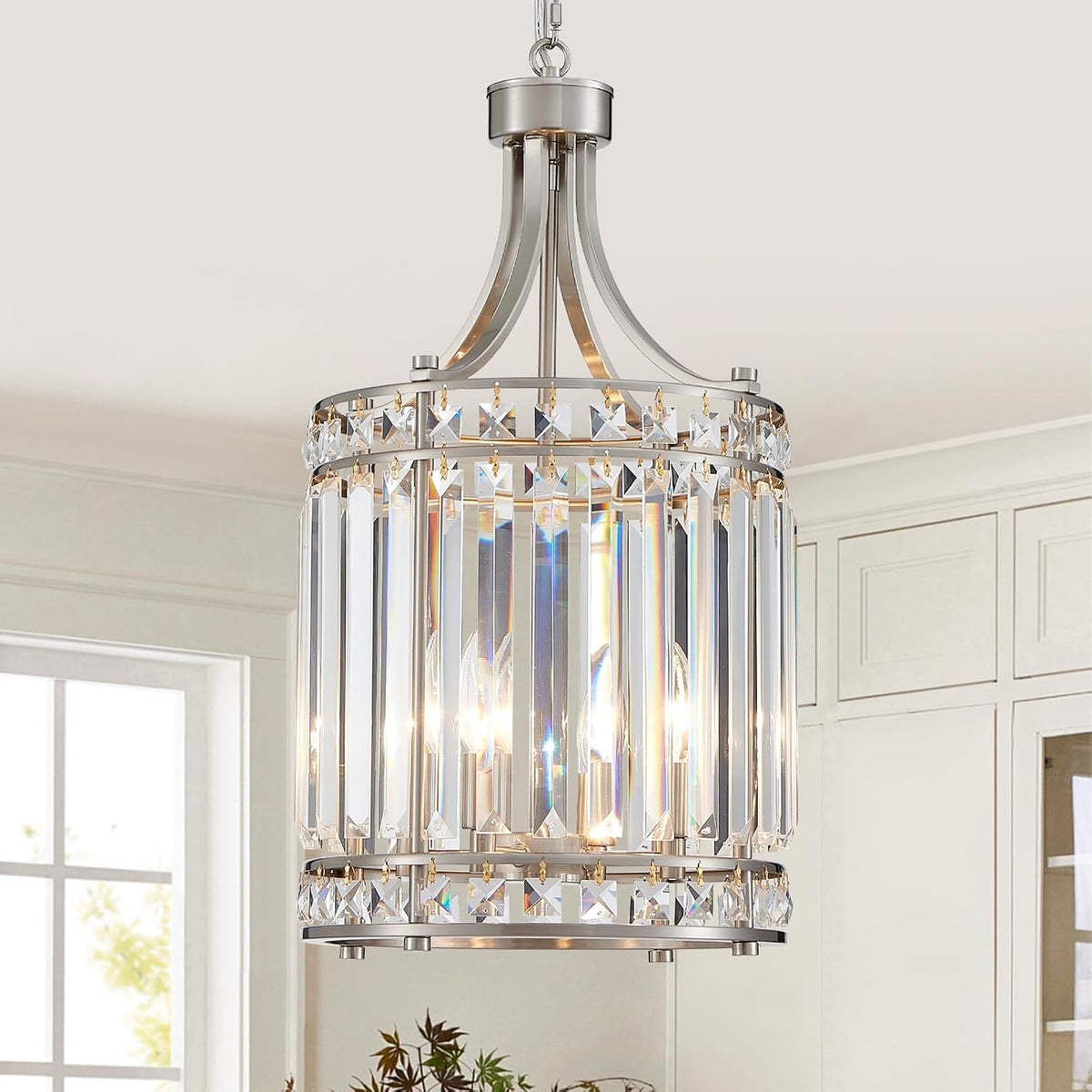 Silver-finish crystal pendant chandelier with vertical K9 crystal bars hanging in a bright kitchen.