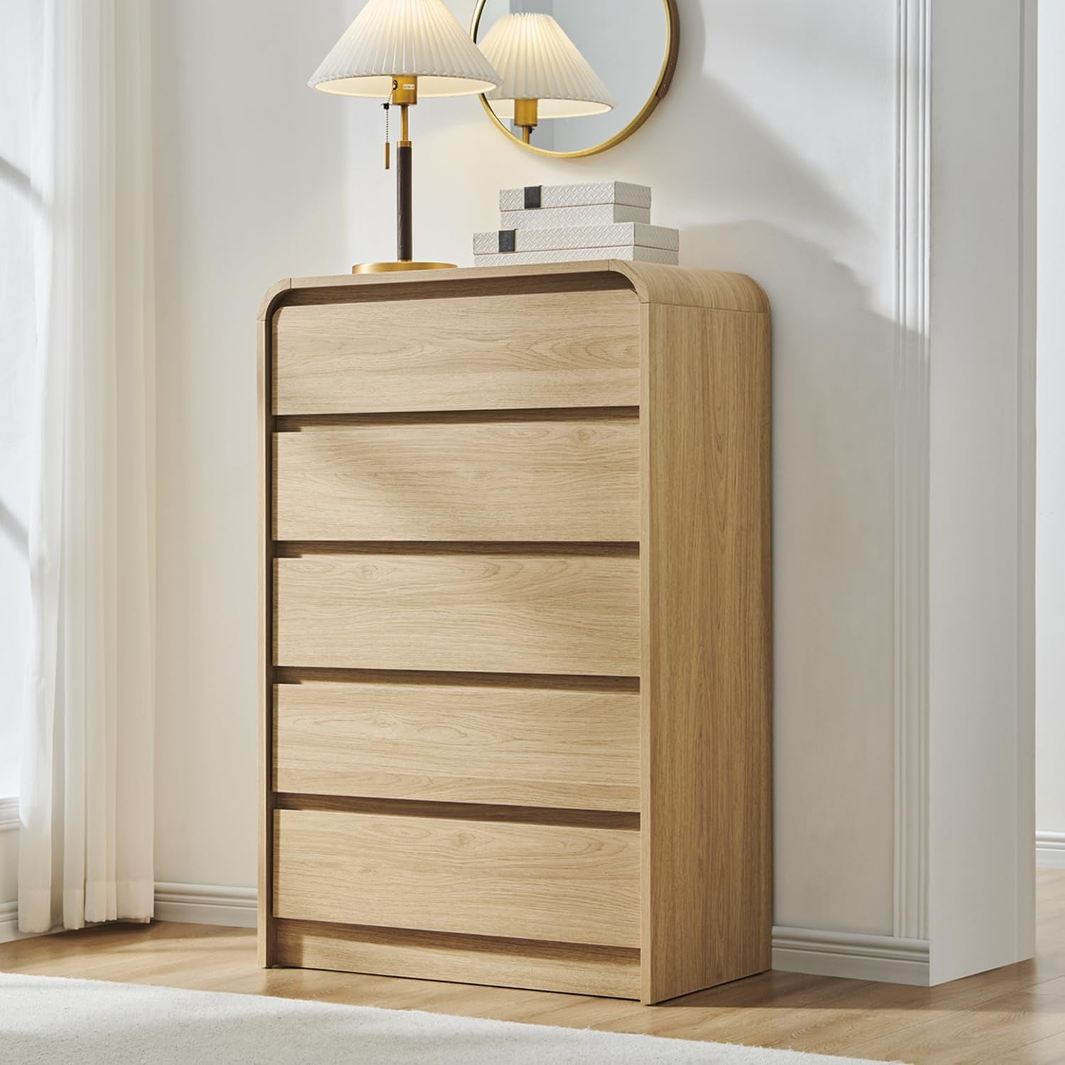 Three-quarter view of the oak dresser highlighting the rounded top corner and visible wood grain under soft light.
