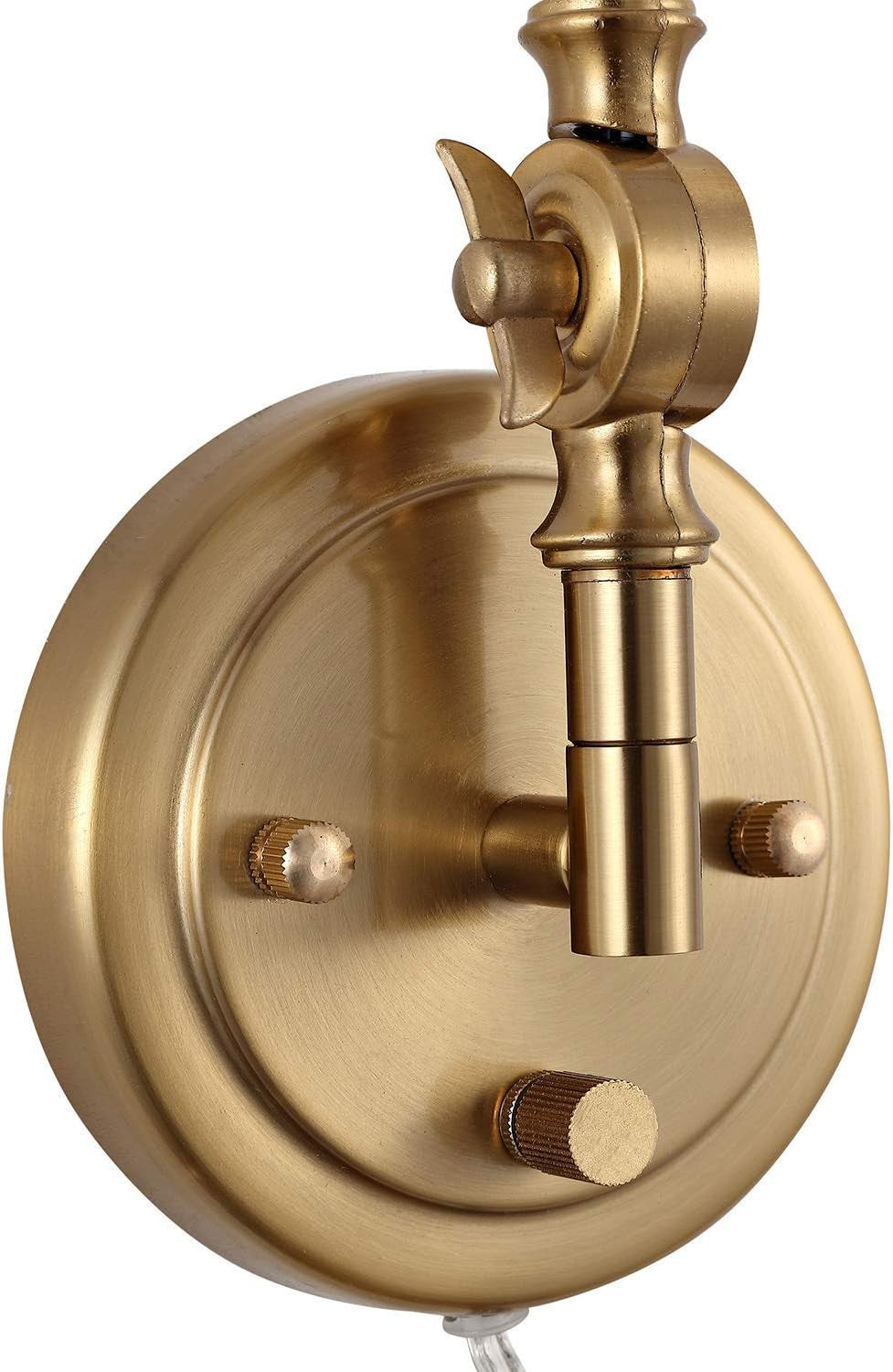 Close-up of a round metal wall plate and adjustable arm joint in warm brass finish.