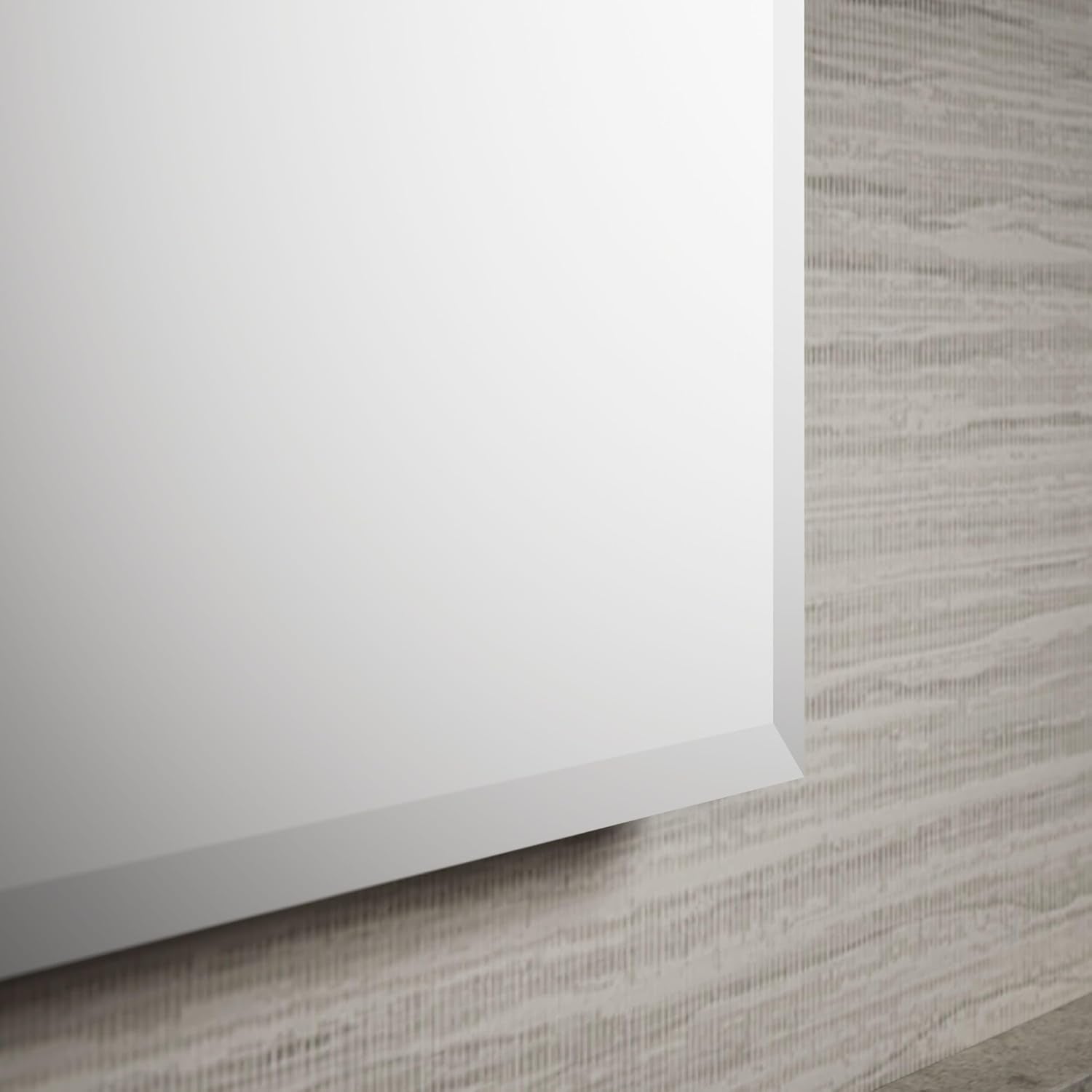 Close-up lower-corner view of the cabinet's 1/2 in beveled mirror edge against a textured wall.