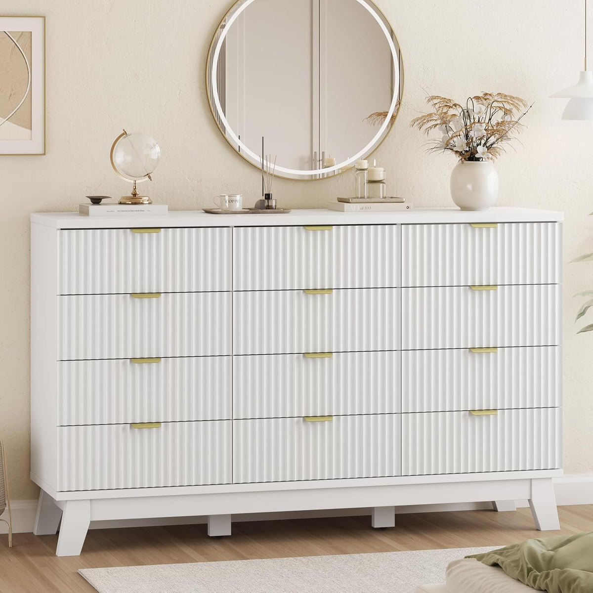Front view of a white wave-panel dresser beneath a round mirror with gold pulls