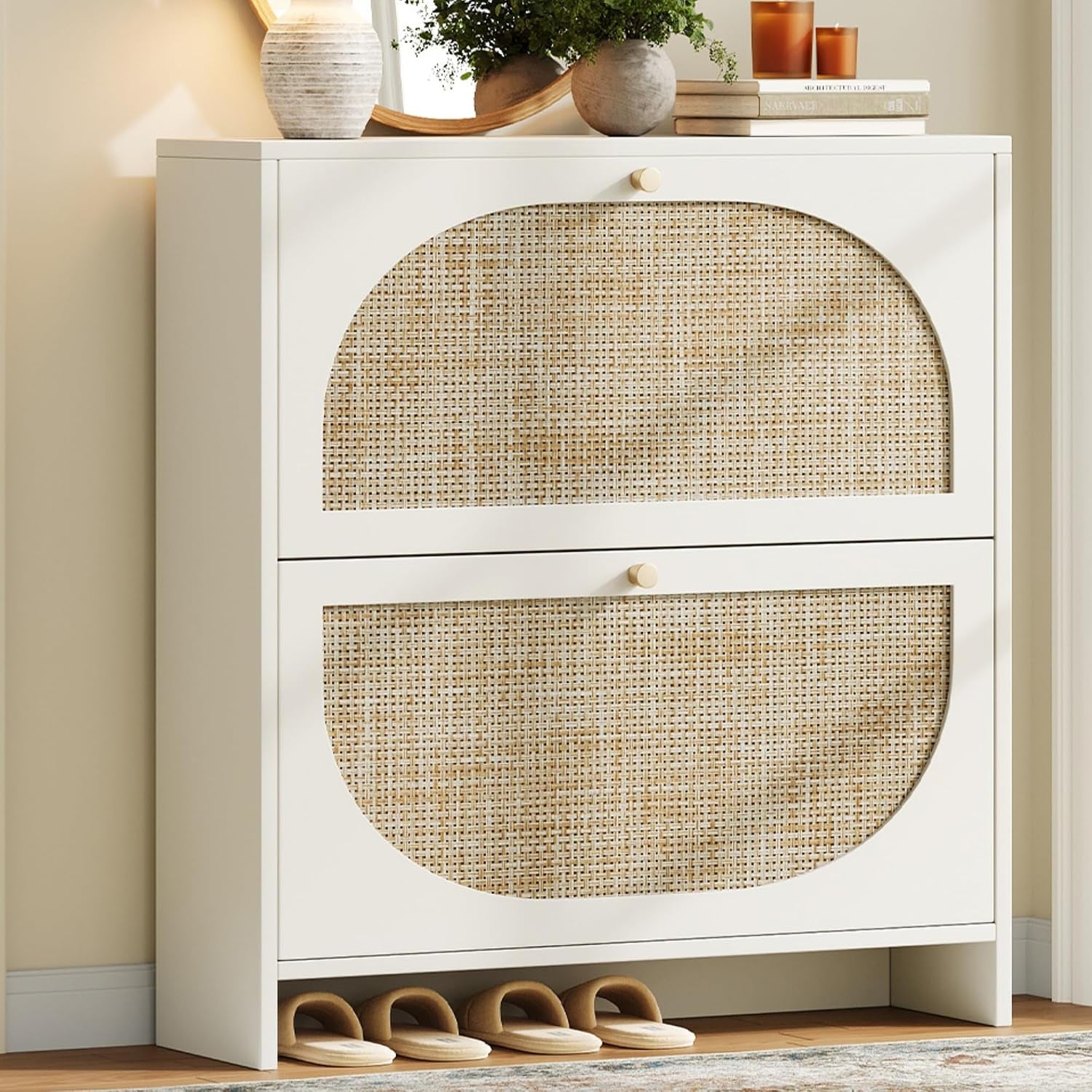 Close-up of the white cabinet showing two arched cane-front flip drawers and knob pulls.