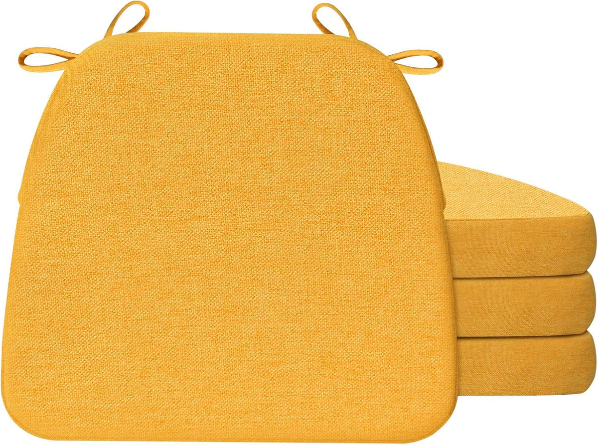 Bright mustard yellow D-shaped cushion shown front-on with tied loops and a stack of three cushions to the right