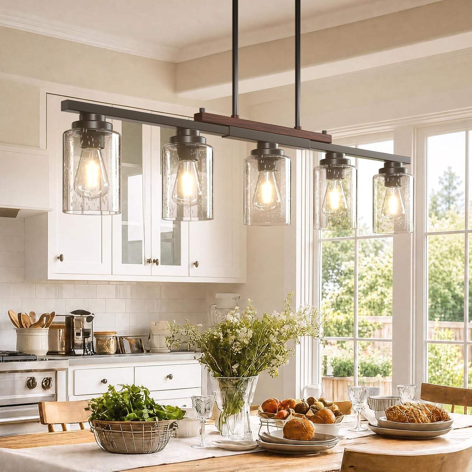 Five-light seeded glass island pendant over a dining table, black metal bar with wood accent, angled front view
