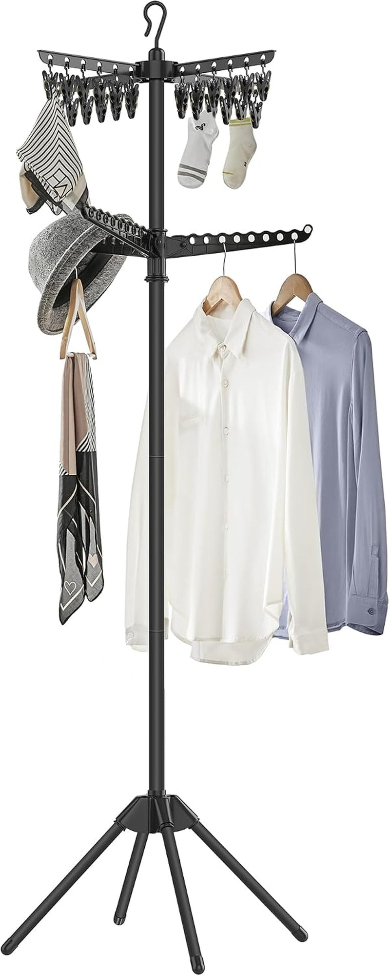 Black freestanding clothes drying rack with three arms holding shirts, socks, a hat and scarves.