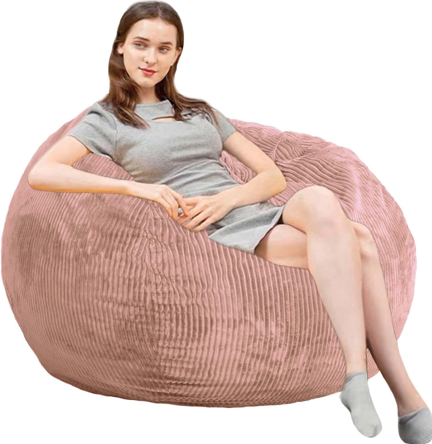 Side view of a woman reclining on a large ribbed pink round bean bag chair.
