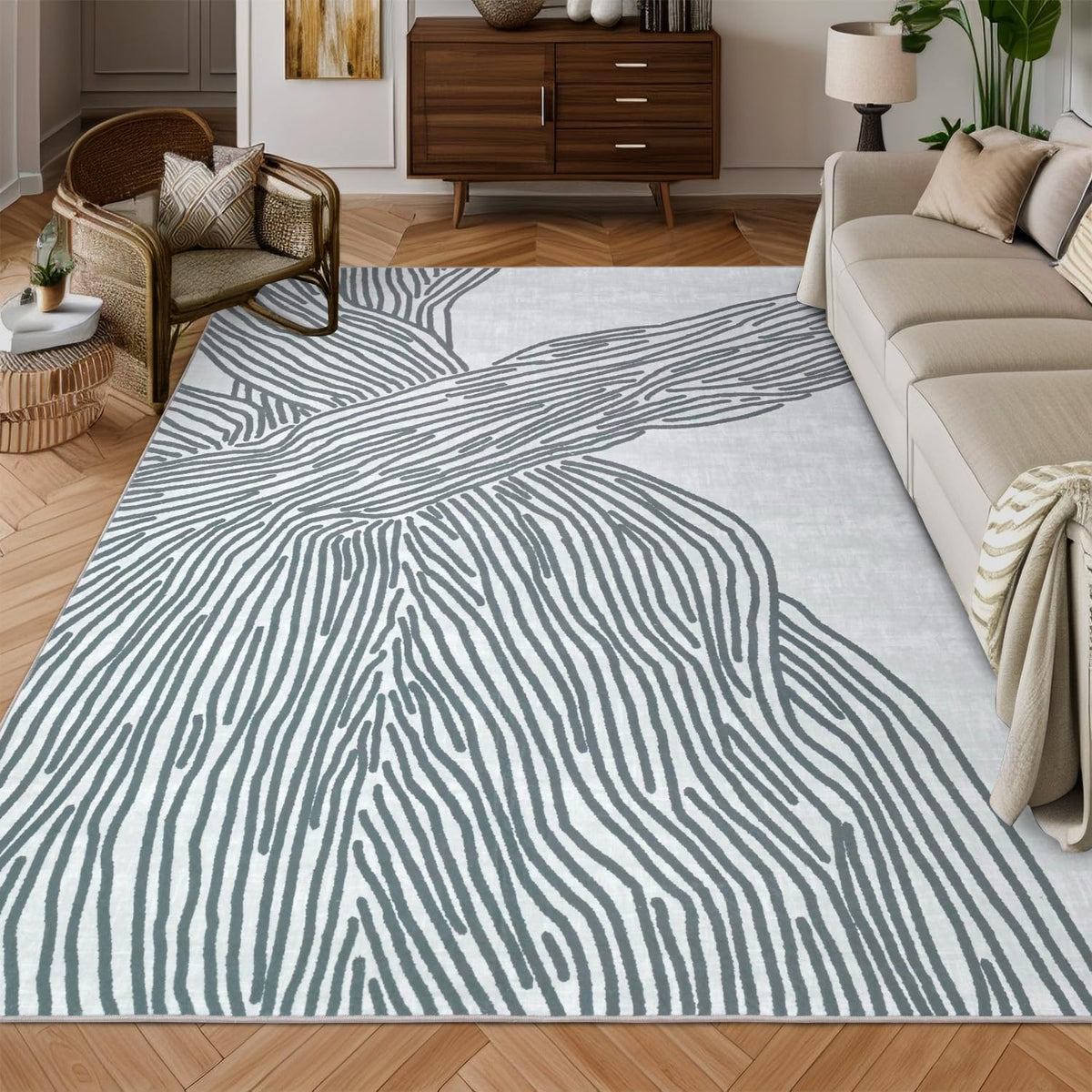 Pale gray rug with broad charcoal linear abstract design in a living room with sofa and midcentury credenza.