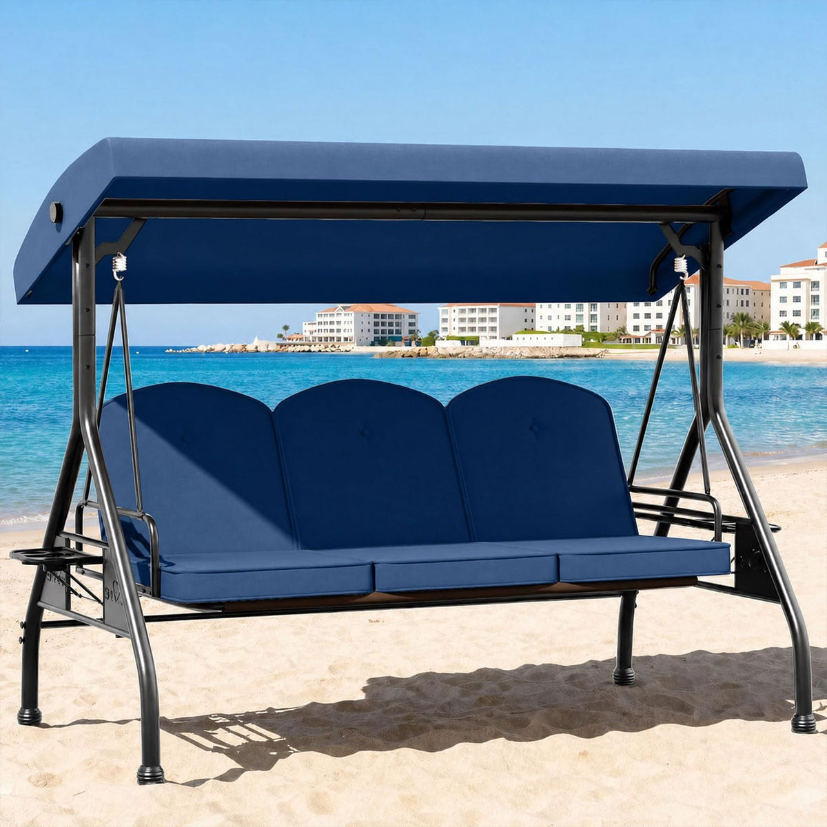 Blue 3-seat patio swing with canopy and cushions shown front angled on a sandy beach