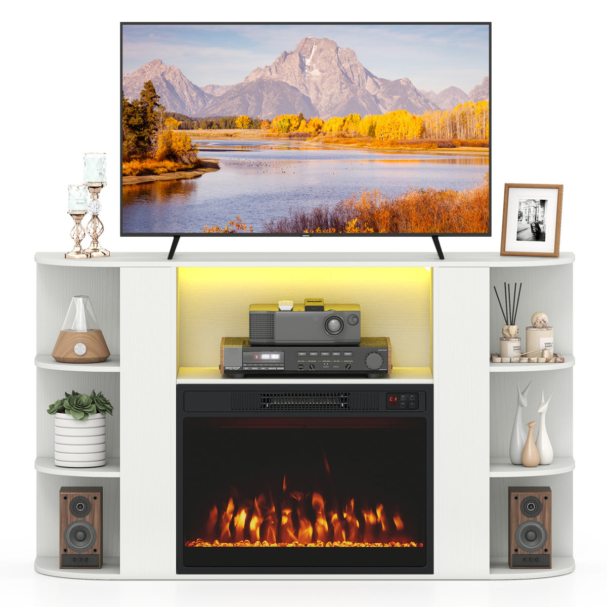White fireplace TV stand with open side shelves, a TV on top, and a lit central fireplace.