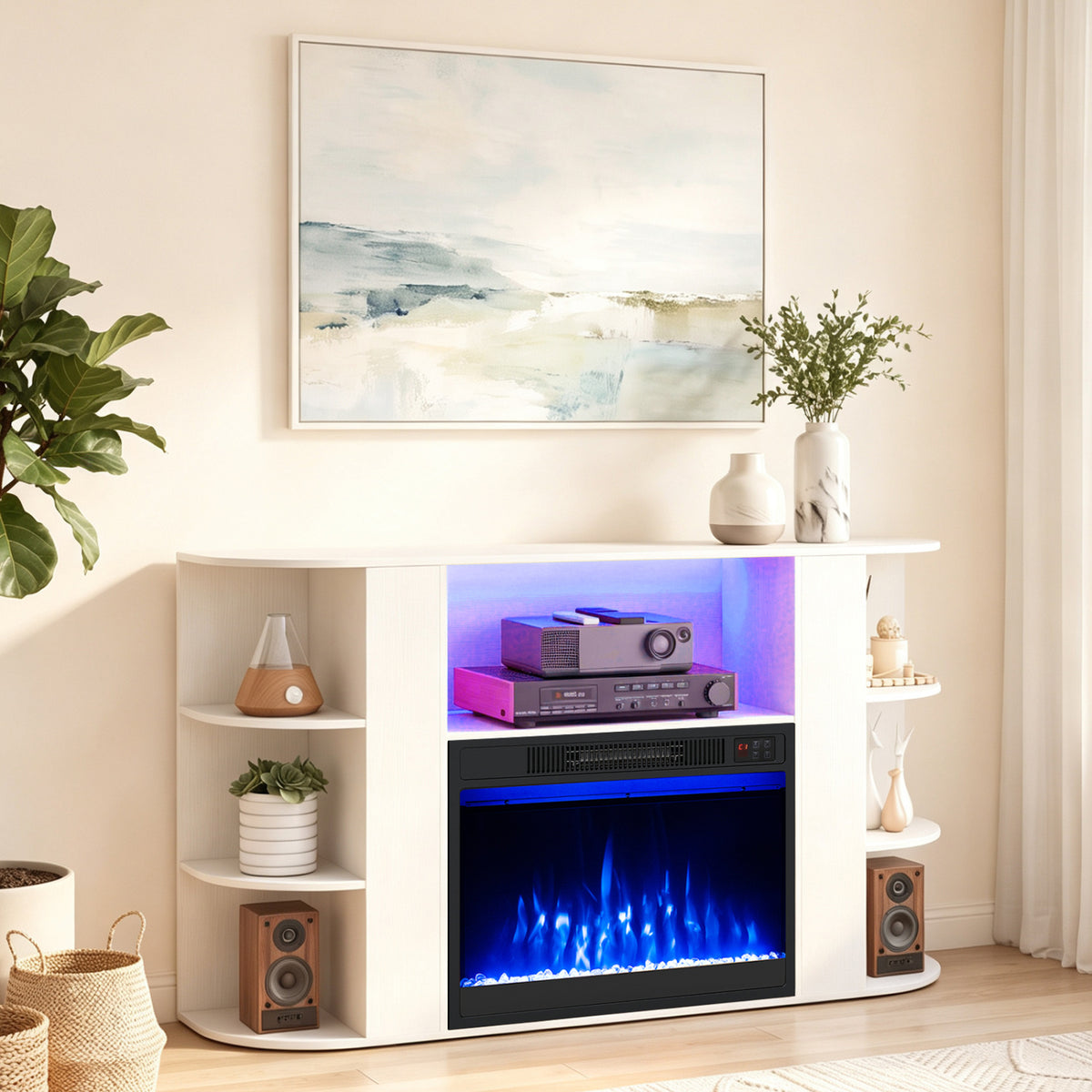 White media console with blue-lit electric fireplace, open shelves, speakers, and a projector in a bright living room.