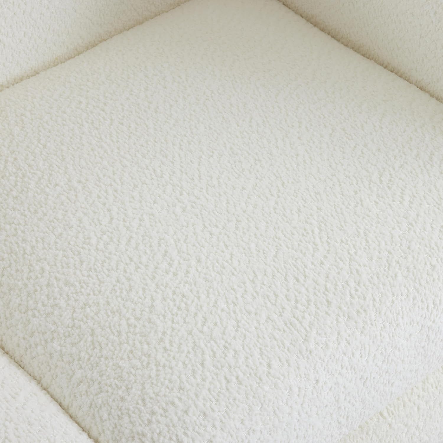Close-up of cream boucle upholstery showing its soft, nubby textured weave on a seat surface.