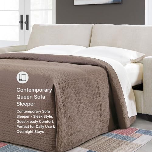 Sofa converted to a queen bed with bedding to show the pull-out sleeper function and the 4-inch memory foam mattress in use