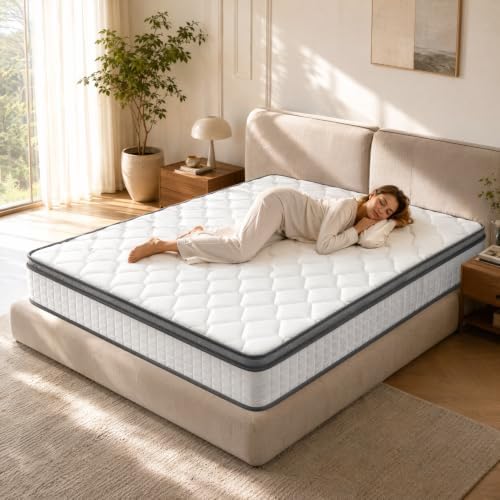 Three-quarter view of a white quilted memory foam mattress on a beige platform bed with a woman sleeping on top